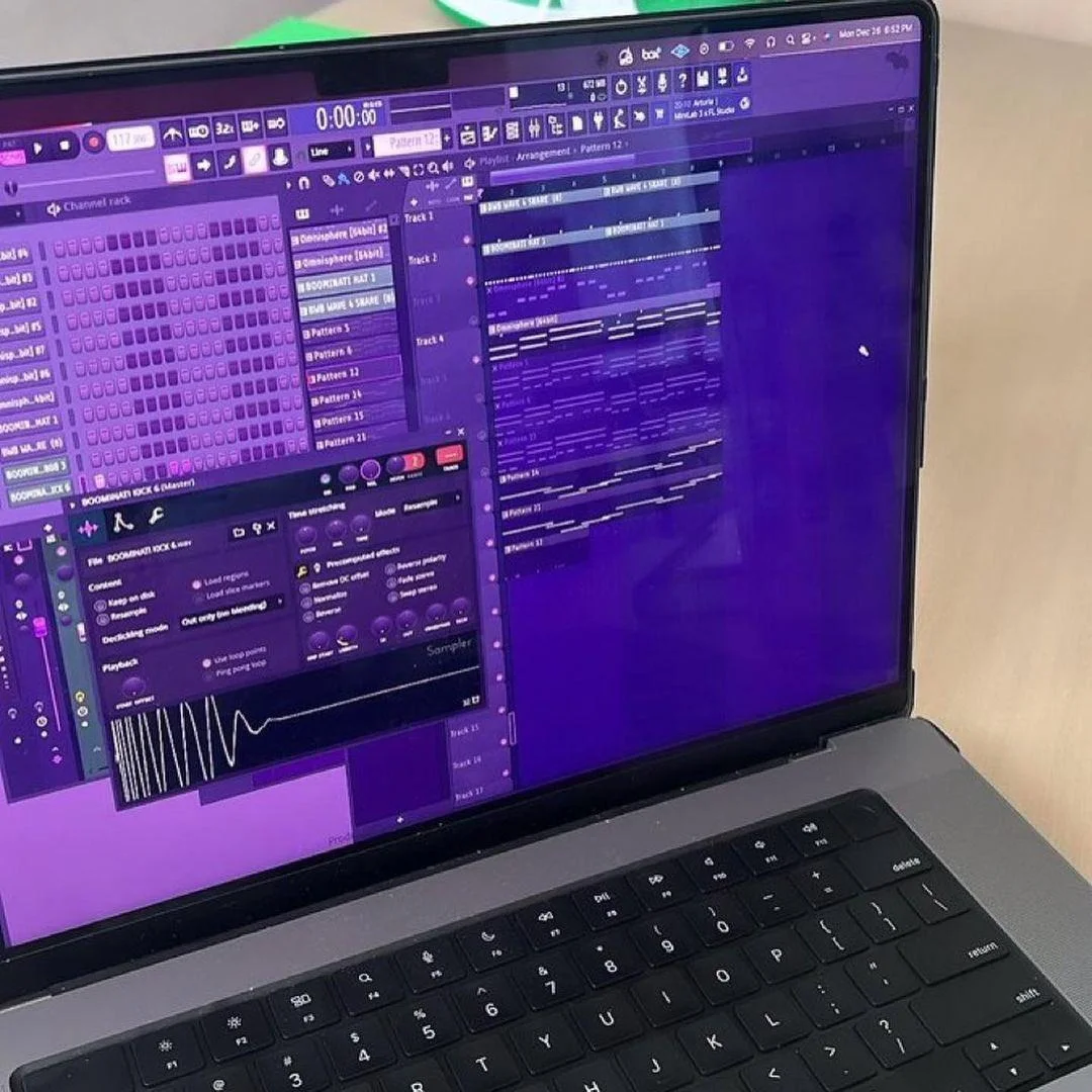 Close-up of FL Studio showing a track arrangement on a laptop